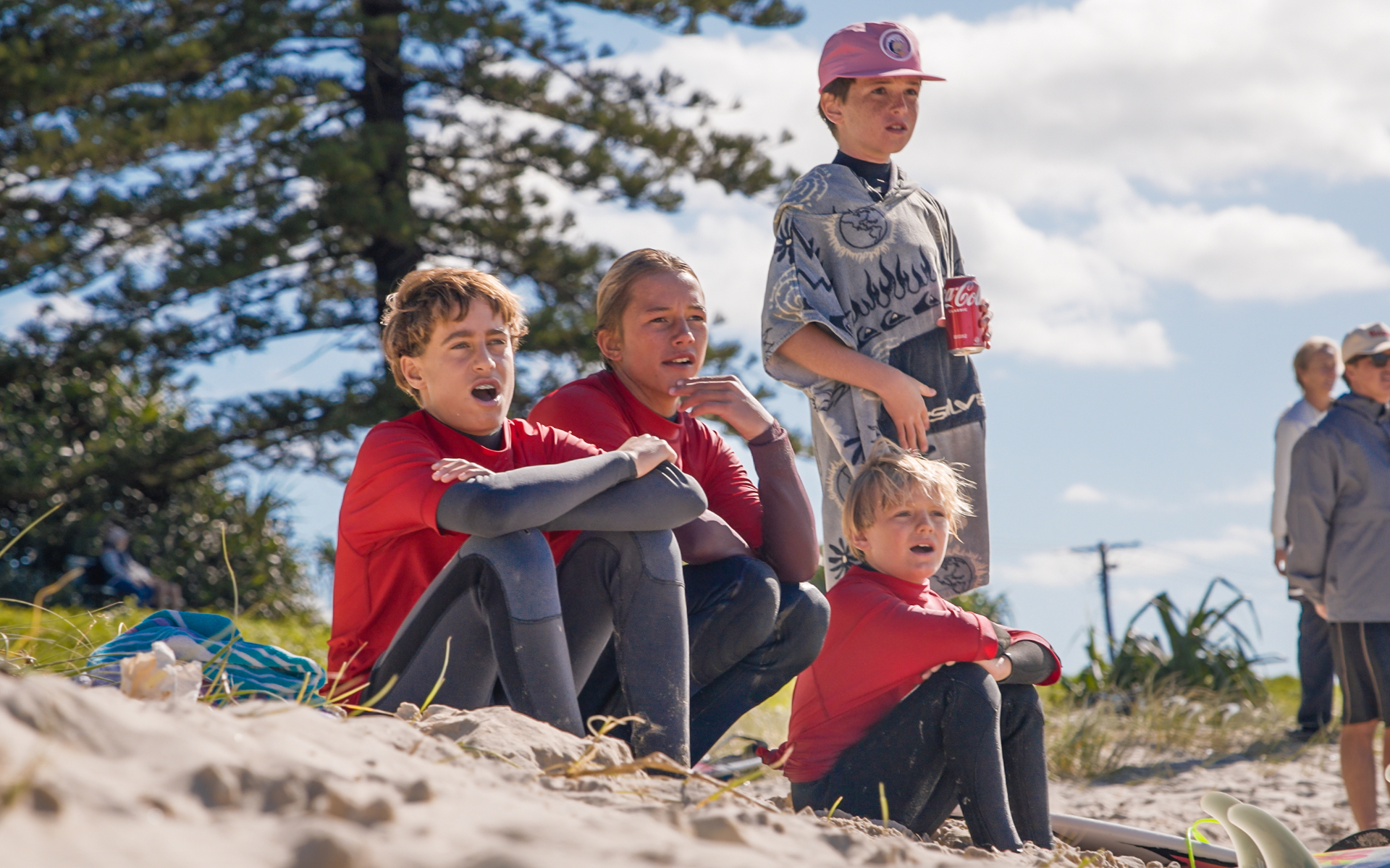 Young people in wetsuits gathered for a Healthy Minds Club community event